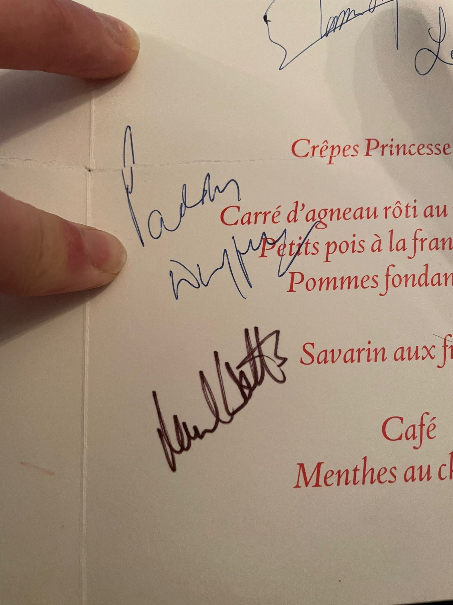 Menu interior showing food courses, wines, and multiple signatures